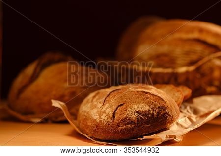 Different Buns Of Fresh Bread On A Brown Vintage Background. Freshly Baked Wheat Bread, Still Life W