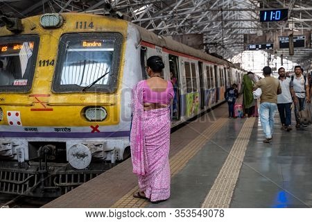 Mumbai, India - February 29, 2020: Indian Woman Wearing A Sari Waits For Her Train At Chatrapati Shi