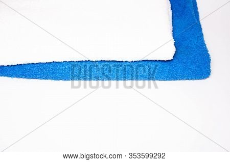 Ironed Towels In Blue And White On A White Background. View From The Top, Side. Macro. Place For Tex