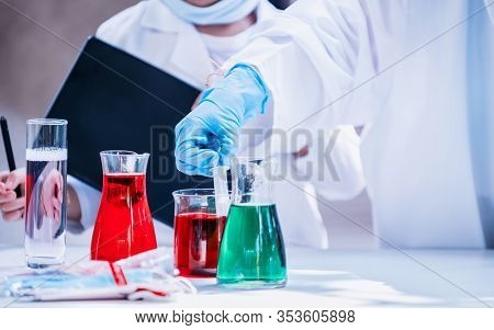 Asian Scientist Working In Science And Chemical For Health. Doctor With Virus In Lap Test To Protect