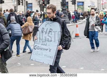 London / Uk - February 22nd 2020 - Male Protester Holds A Sign About Child Deaths In Glencore Mines 