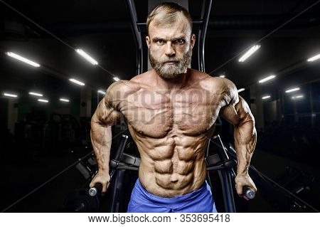 Bodybuilder Pumping Up Chest Muscles Push-ups Bars