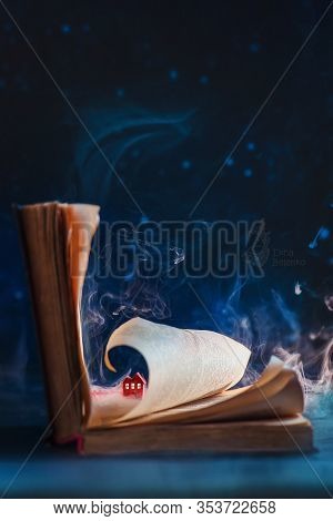Open Book With A Tiny Red Paper House Under A Page, Reading Concept With Papercraft