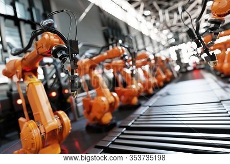 Robotic arms along assembly line in modern factory. Heavy industry, technology and machine learning. 3D rendering