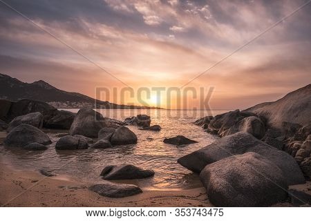 Sunset Over Beach And Village Of Algajola In Corsica