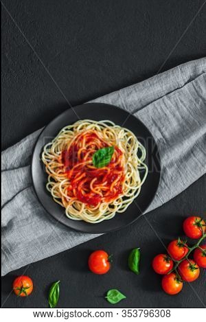 Сlassic Italian Spaghetti Pasta With Tomato Sauce And Basil On Plate On Dark Table. View From Above,
