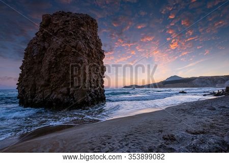 Fyriplaka beach and waves of Aegean sea on sunset, Milos island, Cyclades, Greece
