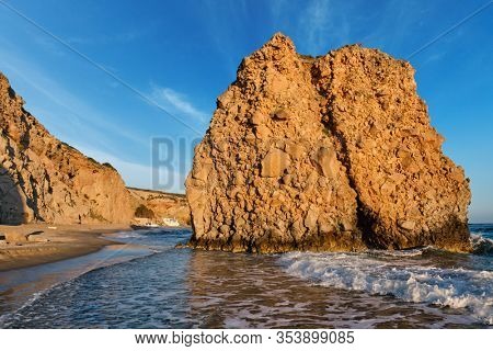 Fyriplaka beach and waves of Aegean sea on sunset, Milos island, Cyclades, Greece