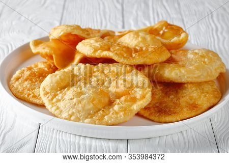 Close-up Of Bhatura, Indian Deep Fried Leavened Bread On A White Platter On A Wooden Table, Horizont
