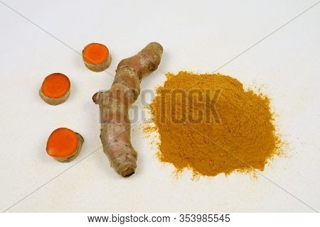 Turmeric Powder And Fresh Turmeric Roots Isolated On A White Background Are Used As An Ingredient In