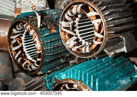 Broken Electric Motors Being Repaired In A Garage. Stator, Industrial Electrical Equipment Close-up.