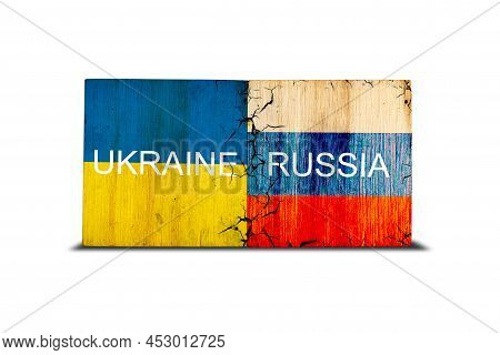 Flags Of Ukraine And Russia On Wooden Blocks. Isolated On White Background. Conflict Between Ukraine
