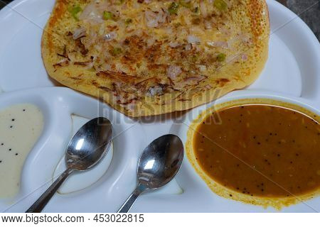 Uttapam Is Served With Chutney On White Plate, Indian Vegetable Dish.