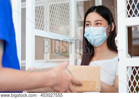 Asian Young Woman, Client Received A Delivery Of Cardboard Box, Parcel From Delivery, Postman, Weari