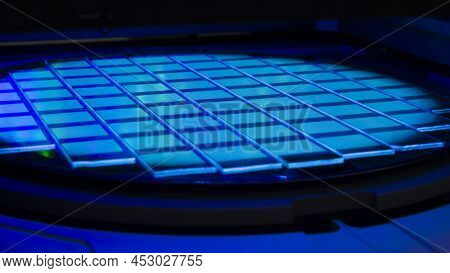 Silicon Wafer With Chips In Uv Lighting. Neon. Ultraviolet Lithography.