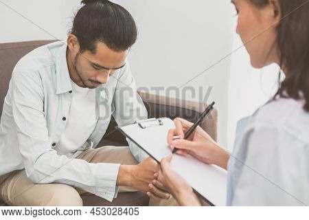 Asian Young Man, Male Has Mental Symptoms Which Must Have Been Therapy And Stress, Sitting On Couch,