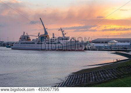 Cuxhaven, Germany - 02.25.2022: Sunrise By The Sea With Helgoland Ferry Docked In The Port Of Cuxhav