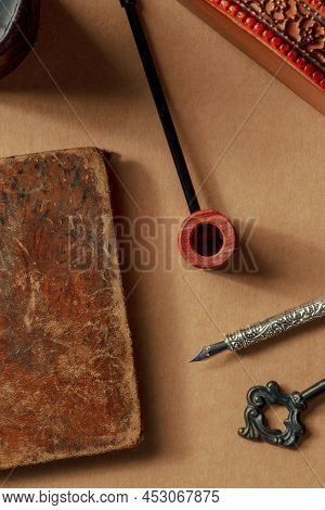 A Vintage Pipe And An Old Notebook, Retro Objects. The Concept Of A Journalist Or A Sleuth, Overhead