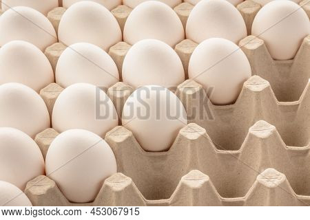 Chicken Eggs White In A Tray. Some Slots In The Tray Are Empty. Top View At An Angle.