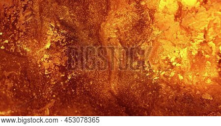 Glitter Ink Background. Paint Mix. Volcanic Eruption. Hot Lava Leak. Defocused Orange Golden Color G