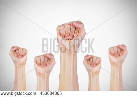 Many Clenched Fists Punch Air Energetically On Gray Background. Together We Stand !