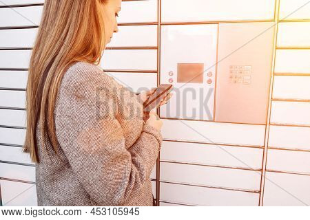 Delivery Locker. Post Automat Terminal And Hands With Parcel Courier Box. Online Purchase Delivery S