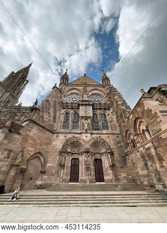 Strasbourg, France - Apr 10, 2022: Young Girl On The Staircases Of Strasbourg Cathedral Or The Cathe