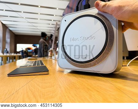Paris, France - Ap 7, 2022: Pov Male Hand Hoilding New Mac Studio Macintosh - A Small Form Factor Wo