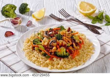 Quinoa Topped With Stir Fried Broccoli, Julienne Carrots, Sun Dried Tomatoes, Leek And Mushrooms On 