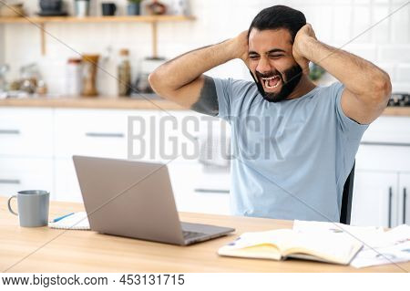 Indian Man Get A Bad News. Angry Annoyed Indian Man, Freelancer Or Designer, Emotionally Yells At A 