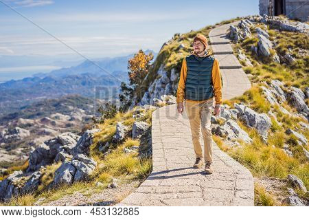 Man Traveller In Mountain Landscape At National Park Lovcen, Montenegro. Travel To Montenegro Concep