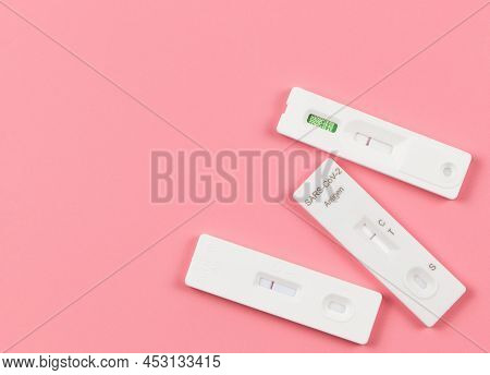 Top View Or Flat Lay Of Covid-19 Three Negative Test Result Antigen Test Kits (atk)  On Pink  Backgr