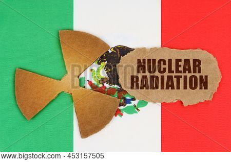 The Concept Of Industry And Radiation. On The Flag Of Mexico, The Symbol Of Radioactivity And Torn C