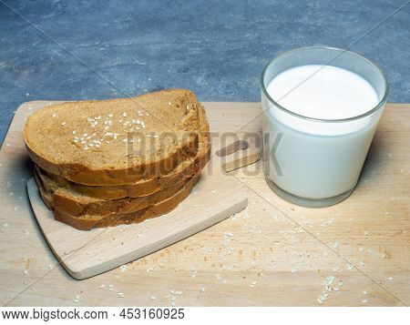 Sliced ​​loaf Bread For Breakfast With Butter. Food On The Table. Flour Products. Pieces Of Bun . Co