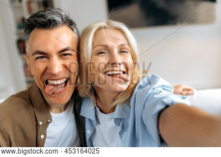 Funny Married Mature Couple, Middle Aged Caucasian Husband And Wife Fooling Around, Taking A Selfie 