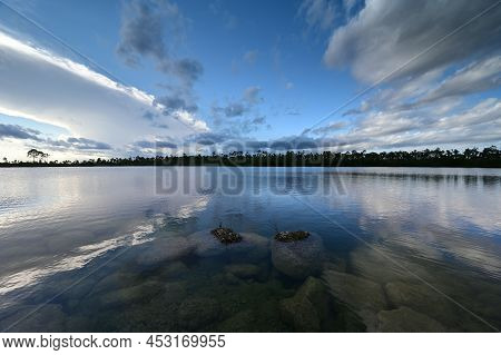 Beautiful Late Afternoon Cloudscape Over Pine Glades Lake In Everglades National Park, Florida Refle