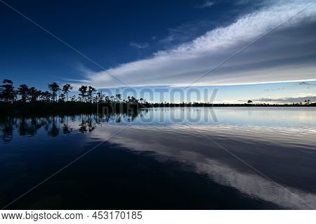 Beautiful Late Afternoon Cloudscape Over Pine Glades Lake In Everglades National Park, Florida Refle