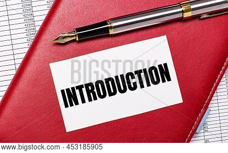 On The Desktop There Are Reports, A Burgundy Notebook, A Fountain Pen And A White Blank Card With Th
