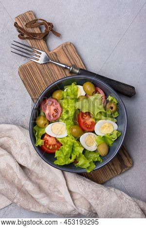 Healthy Salad With Fresh Lettuce, Cherry Tomatoes, Quail Egg And Olives