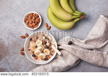 Healthy Breakfast With Oatmeal, Nuts, Banana And Chocolate Drops
