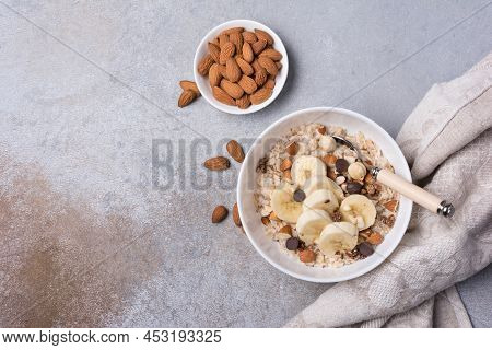 Healthy Breakfast With Oatmeal, Nuts, Banana And Chocolate Drops