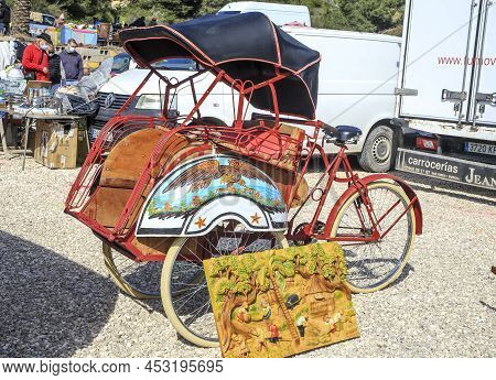 Guardamar, Alicante, Spain- April 3, 2022: Red Chinese Tricycle For Sale At The Flea Market Called E