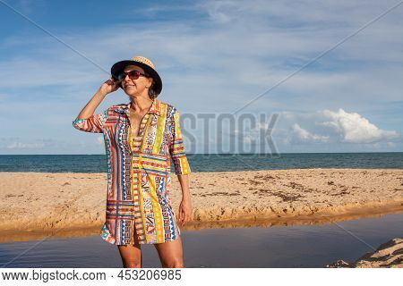 Woman Wearing Colorful Beachwear At The Beach Known As Pitinga, In Arraial D Ajuda, Bahia, Brazil