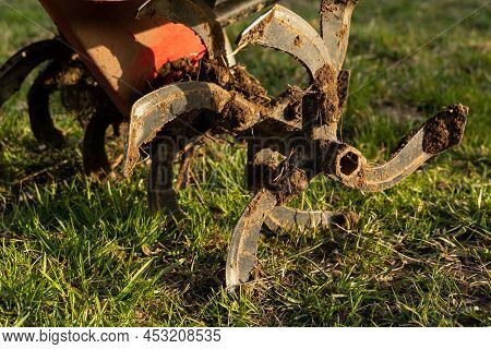Dirty Cultivator Blades Close-up. Tilling The Land On The Farm. Farming.