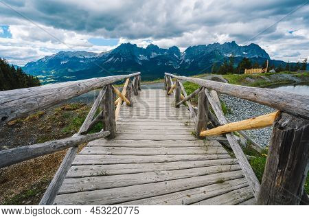 Small Bridge At Astberg Lake With Wilderkaiser Mountains In Background. Ellmau, Austria
