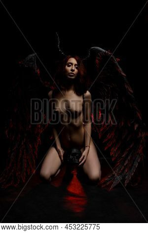Sexy Naked Woman In Fallen Angel Costume With Skull
