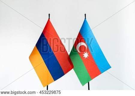 State Flags Of Azerbaijan And Armenia On Light Background. Karabakh Conflict, Cooperation, Negotiati