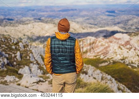Man Traveller In Mountain Landscape At National Park Lovcen, Montenegro. Travel To Montenegro Concep