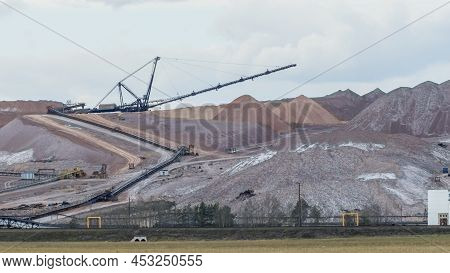 Giant Spreader Or Absetzer Machinery. A Large Dumper On A Landfill With Potash Ore. Extracting Potas