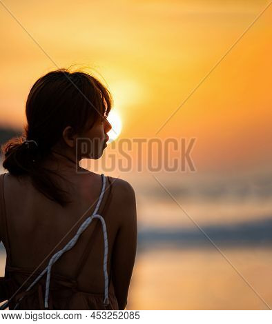 Asian Woman In Silhouette Mood And Tone Of Picture With Orange Warm Sunset Blurs, Background On Kata